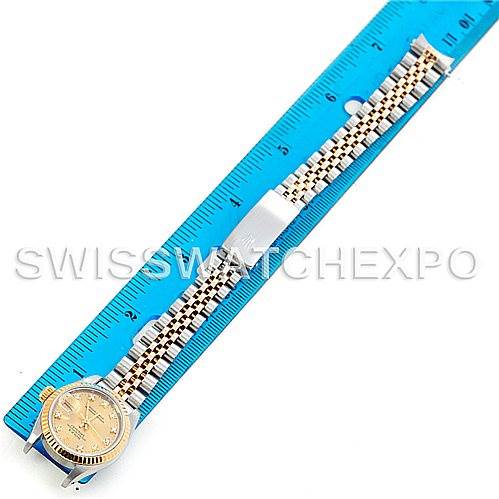 The image shows a Rolex Datejust 69173 Women's Stainless Steel Champagne Dial 69173 Women's Stainless Steel Champagne Dial watch placed next to a blue ruler, showcasing its band and case from a top-down angle.