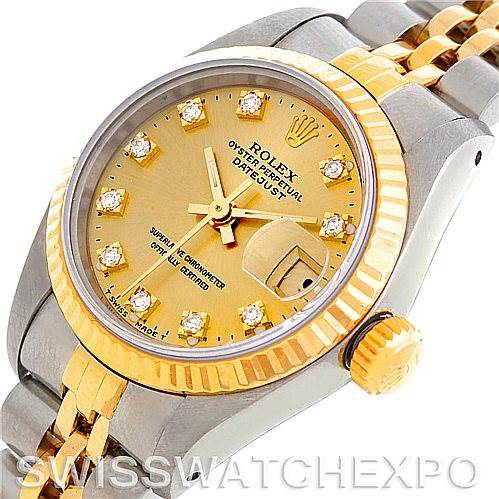 This image shows a Rolex Datejust 69173 Women's Stainless Steel Champagne Dial 69173 Women's Stainless Steel Champagne Dial watch from an oblique angle, highlighting its gold dial, fluted bezel, and two-tone bracelet.