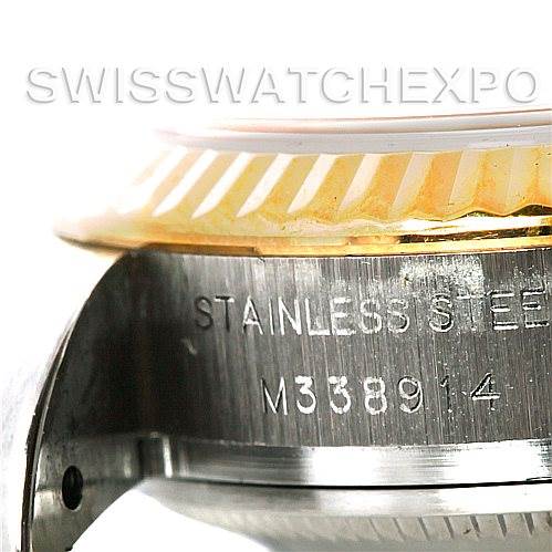 This close-up angle shows the watch case and the fluted bezel of a Rolex Datejust 179173 Women's Steel and Gold (two tone) Beige Dial 179173 Women's Steel and Gold (two tone) Beige Dial, along with the serial number engraved on the case.