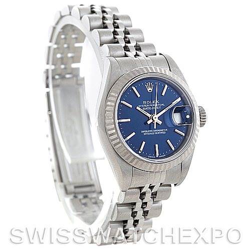 The image shows a Rolex Datejust 79174 Women's Stainless Steel Blue Dial 79174 Women's Stainless Steel Blue Dial watch from an angled side view, highlighting its blue dial, fluted bezel, and Jubilee bracelet.