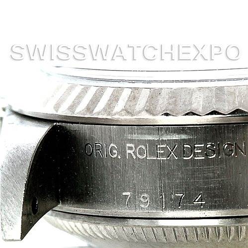 This image shows a close-up view of the side of a Rolex Datejust 79174 Women's Stainless Steel White Dial 79174 Women's Stainless Steel White Dial watch, focusing on the engraving "ORIG. ROLEX DESIGN" and the serial number.