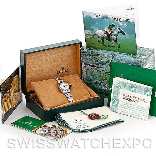 The image shows a Rolex Datejust 69174 Women
s Stainless Steel Mother of Pearl Dial 69174 Women
s Stainless Steel Mother of Pearl Dial watch along with its box, warranty card, booklet, and various papers and accessories.