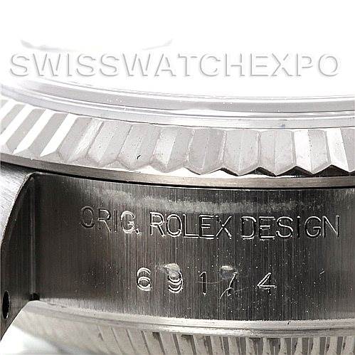 The image shows a close-up angle of the side of a Rolex Datejust 69174 Women
s Stainless Steel Mother of Pearl Dial 69174 Women
s Stainless Steel Mother of Pearl Dial watch with the model number 69174 engraved.
