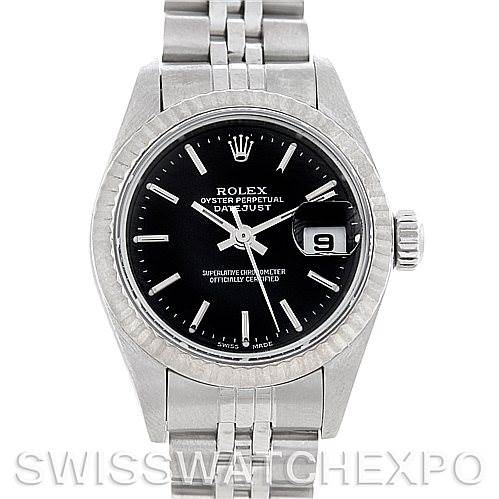 The image shows a front view of a Rolex Datejust 79174 Women's Stainless Steel Black Dial 79174 Women's Stainless Steel Black Dial watch with a black dial, silver bracelet, and date display at the 3 o'clock position.