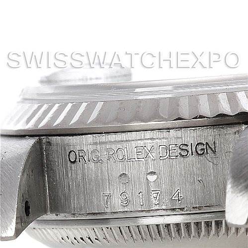 This image shows a close-up, side angle view of a Rolex Datejust 79174 Women's Stainless Steel Black Dial 79174 Women's Stainless Steel Black Dial watch, focusing on the case side with the engraved serial number.