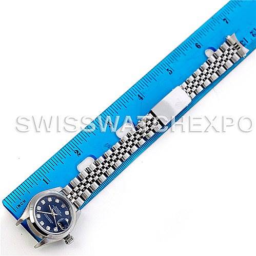 This image shows a Rolex Datejust 79240 Women's Stainless Steel Blue Dial 79240 Women's Stainless Steel Blue Dial watch model laid flat beside a ruler, displaying the face, bracelet, and crown.