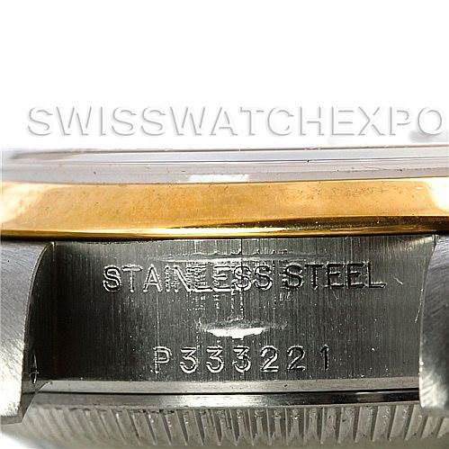 The image shows a close-up of the side of the Rolex Datejust 79163 Women's Steel and Gold (two tone) Mother of Pearl Dial 79163 Women's Steel and Gold (two tone) Mother of Pearl Dial watch case, highlighting the "Stainless Steel" engraving and serial number.