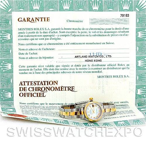 The image shows a Rolex Datejust 79163 Women's Steel and Gold (two tone) Mother of Pearl Dial 79163 Women's Steel and Gold (two tone) Mother of Pearl Dial watch along with its warranty and official chronometer certification papers placed underneath.