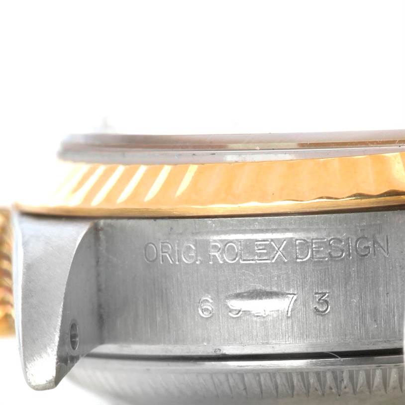 The image shows the side view of a Rolex Datejust 69173 Women's Stainless Steel White Dial 69173 Women's Stainless Steel White Dial watch case with "ORIG. ROLEX DESIGN" engraving.