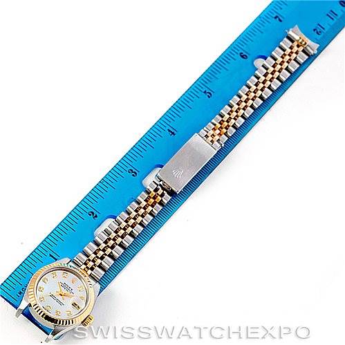 The image shows a Rolex Datejust 79173 Women's Stainless Steel Mother of Pearl Dial 79173 Women's Stainless Steel Mother of Pearl Dial model watch laid flat next to a ruler, highlighting the dial, bracelet, and clasp.