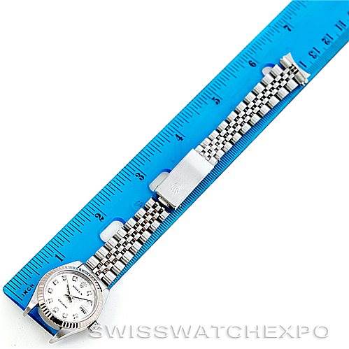 This image shows a Rolex Datejust 79174 Women's Stainless Steel Silver Dial 79174 Women's Stainless Steel Silver Dial watch laid flat beside a blue ruler, displaying the watch face, bracelet, and clasp.