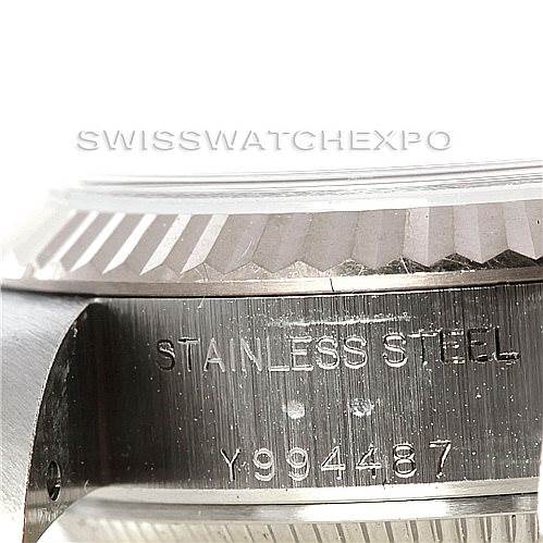 The image shows a close-up of the side of a Rolex Datejust 79174 Women's Stainless Steel Silver Dial 79174 Women's Stainless Steel Silver Dial watch, highlighting the serial number "Y994487" and "STAINLESS STEEL" engraving.