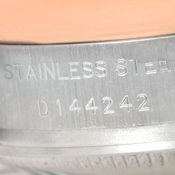 The image shows a close-up of the side of a Rolex Datejust 179161 Women's Steel and Gold (two tone) Black Dial 179161 Women's Steel and Gold (two tone) Black Dial watch, highlighting its stainless steel engraving and serial number.