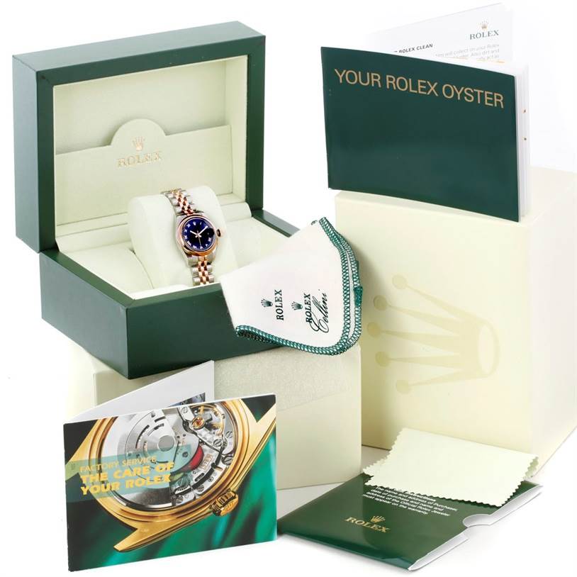 The image shows a Rolex Datejust 179161 Women's Steel and Gold (two tone) Black Dial 179161 Women's Steel and Gold (two tone) Black Dial watch in its box with accompanying accessories, including manuals, a cleaning cloth, and paperwork.