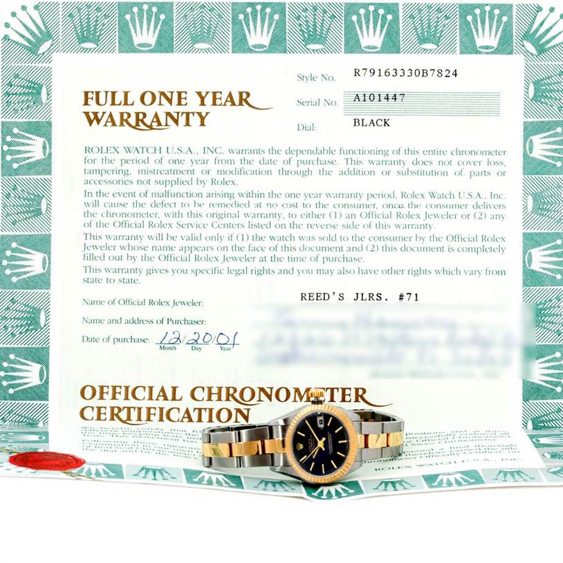 The image shows a Rolex Datejust 79163 Women's Steel and Gold (two tone) Black Dial 79163 Women's Steel and Gold (two tone) Black Dial watch positioned on an official chronometer certification document, viewed from the front and slightly above.