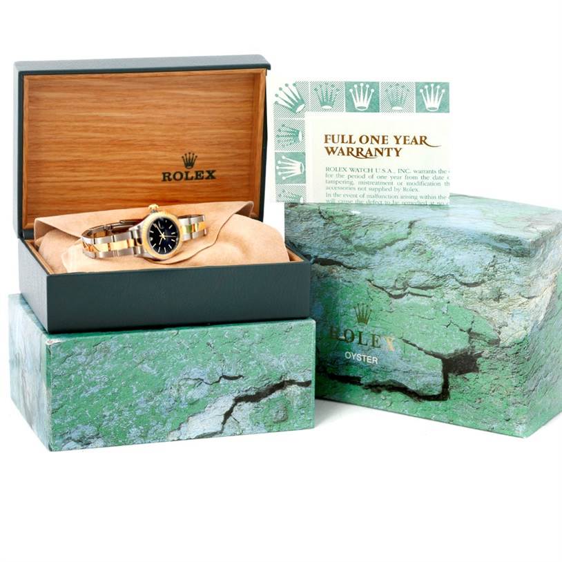 The Rolex Datejust 79163 Women's Steel and Gold (two tone) Black Dial 79163 Women's Steel and Gold (two tone) Black Dial watch is shown in its box with a warranty card, with the box lid open to display the watch and its packaging. 