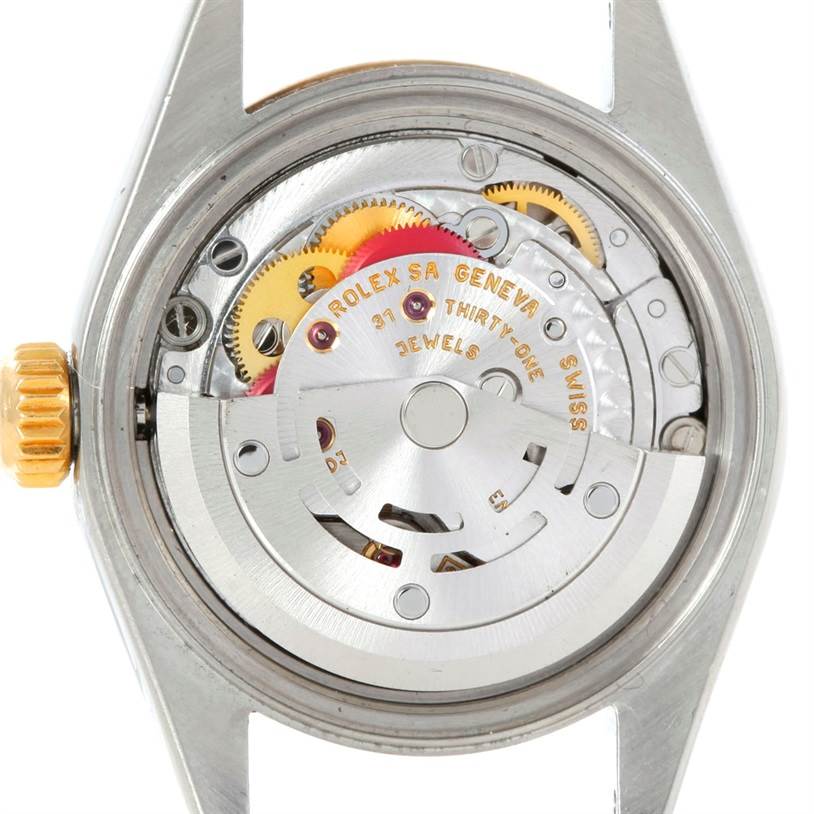 This image shows an internal view of the Rolex Datejust 79163 Women's Steel and Gold (two tone) Black Dial 79163 Women's Steel and Gold (two tone) Black Dial watch, highlighting the movement and mechanical components.