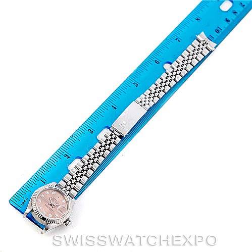 The image shows a Rolex Datejust 69174 Women's Stainless Steel Pink Dial 69174 Women's Stainless Steel Pink Dial watch laid flat with the face, bracelet, and clasp visible next to a blue ruler for scale.