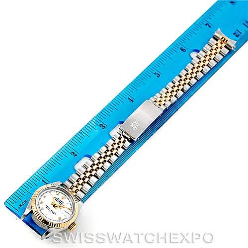 This image shows the Rolex Datejust 69163 Women
s Stainless Steel White Dial 69163 Women
s Stainless Steel White Dial watch laid flat next to a ruler, displaying the face and bracelet.