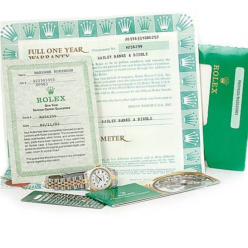 The image shows a Rolex Datejust 69163 Women
s Stainless Steel White Dial 69163 Women
s Stainless Steel White Dial watch along with its warranty papers and green Rolex packaging.