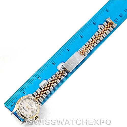 The image shows a Rolex Datejust 69173 Women
s Stainless Steel Beige Dial 69173 Women
s Stainless Steel Beige Dial watch laid flat next to a ruler, highlighting the watch face, bracelet, and clasp.