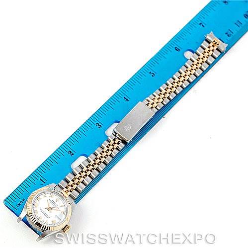 The image shows the Rolex Datejust 69173 Women's Stainless Steel White Dial 69173 Women's Stainless Steel White Dial watch positioned alongside a ruler, displaying the full band and case from a top-down angle.