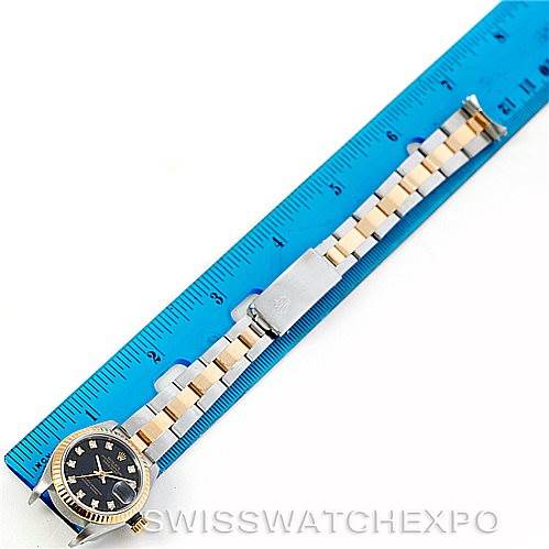 The image shows a top-view angle of a Rolex Datejust 69173 Women's Stainless Steel Black Dial 69173 Women's Stainless Steel Black Dial watch next to a ruler, highlighting the bracelet and watch face.