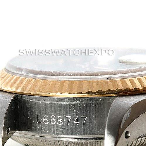 This is a close-up of the case side and bezel of a Rolex Datejust 69173 Women's Stainless Steel Black Dial 69173 Women's Stainless Steel Black Dial watch, showing its serial number and the fluted bezel detail.