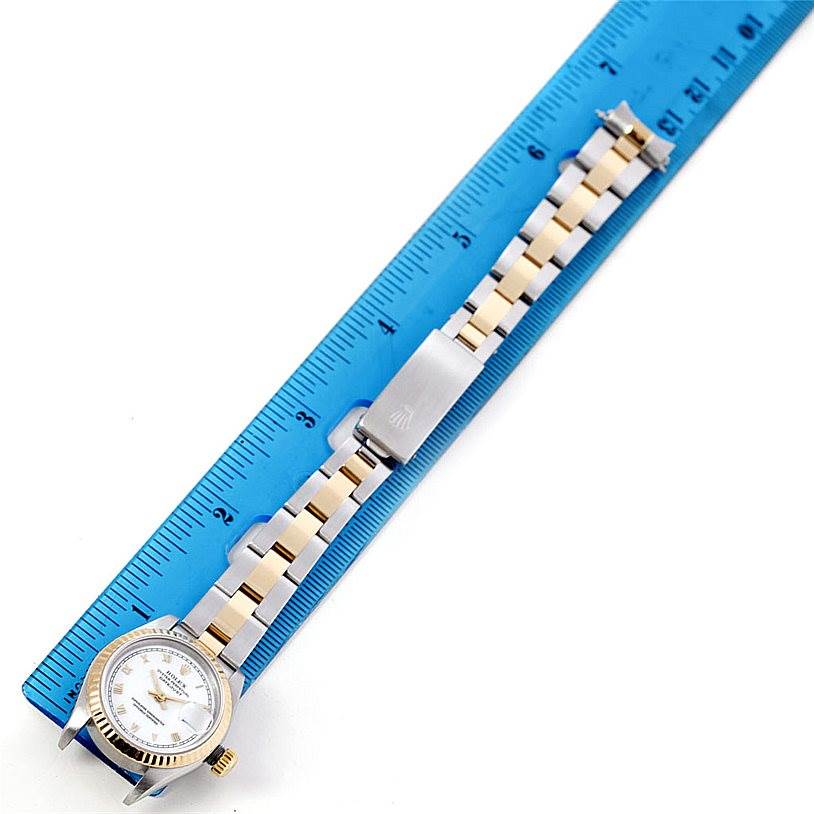 The image shows a Rolex Datejust 69173 Women's Stainless Steel White Dial 69173 Women's Stainless Steel White Dial watch lying flat next to a ruler, highlighting its face, bracelet, and clasp.