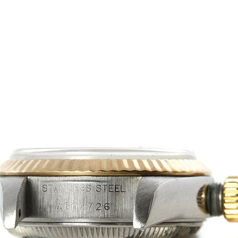 The image shows a close-up side view of the case, bezel, serial number, and crown of a Rolex Datejust 69173 Women's Stainless Steel White Dial 69173 Women's Stainless Steel White Dial watch.