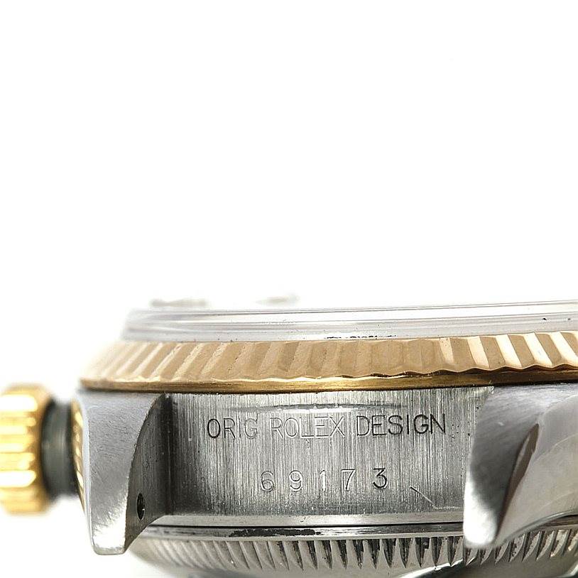 This Rolex Datejust 69173 Women's Stainless Steel White Dial 69173 Women's Stainless Steel White Dial watch photo shows a side angle highlighting the bezel, crown, and part of the case with engraved markings.