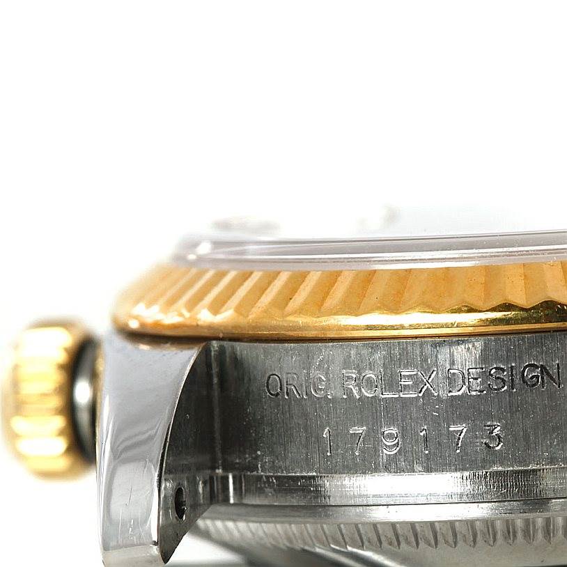 This image shows a close-up of the side and bezel of a Rolex Datejust 179173 Women's Steel and Gold (two tone) Champagne Dial 179173 Women's Steel and Gold (two tone) Champagne Dial watch, featuring engraved serial numbers.