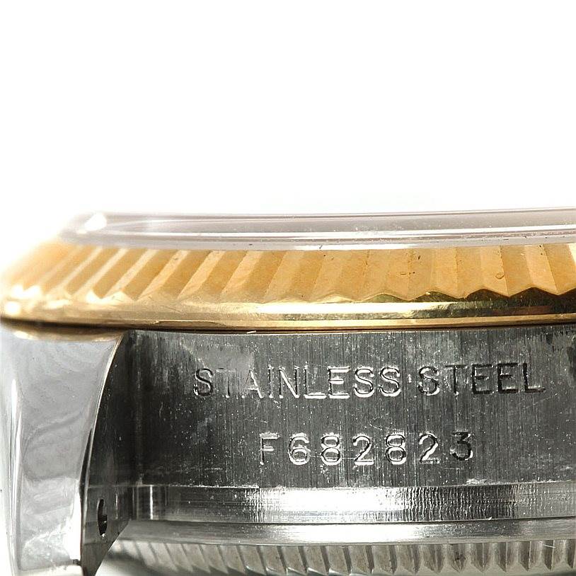 This close-up shows the side of the Rolex Datejust 179173 Women's Steel and Gold (two tone) Champagne Dial 179173 Women's Steel and Gold (two tone) Champagne Dial model, highlighting its stainless steel casing and fluted bezel.