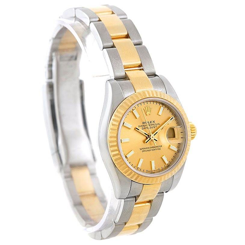 The image shows a Rolex Datejust 179173 Women's Steel and Gold (two tone) Champagne Dial 179173 Women's Steel and Gold (two tone) Champagne Dial watch from a front angle, highlighting its gold and silver bracelet and gold dial.