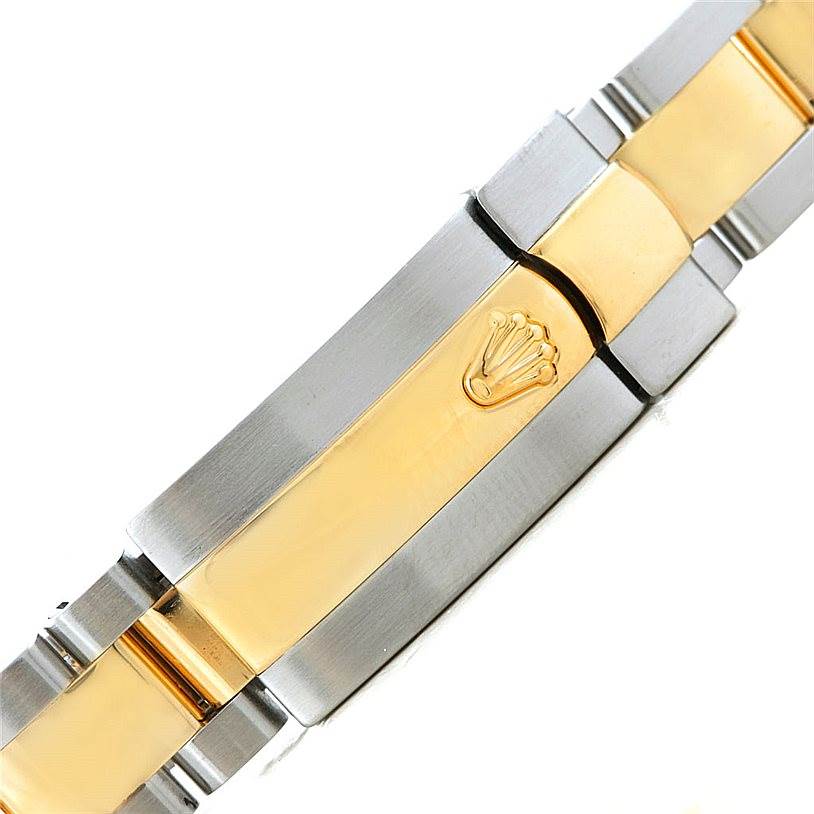 The image shows the clasp of a Rolex Datejust 179173 Women's Steel and Gold (two tone) Champagne Dial 179173 Women's Steel and Gold (two tone) Champagne Dial watch, featuring a two-tone metal finish with the Rolex crown emblem.