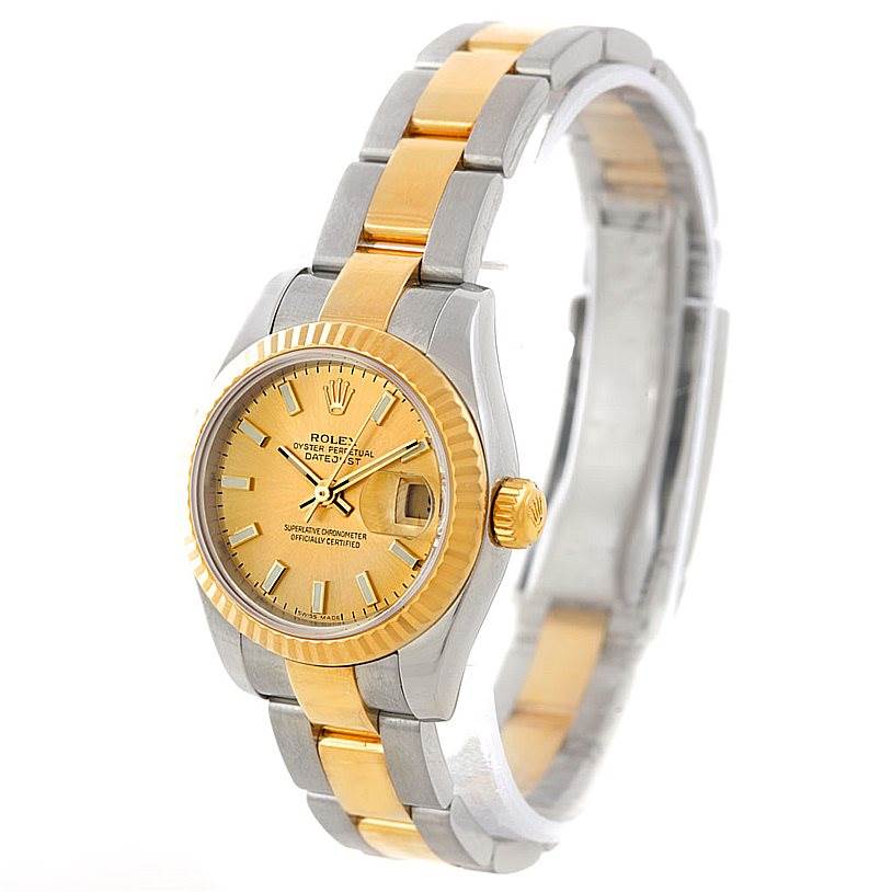 This image shows a Rolex Datejust 179173 Women's Steel and Gold (two tone) Champagne Dial 179173 Women's Steel and Gold (two tone) Champagne Dial watch from an angle showcasing its face, bezel, and bracelet.