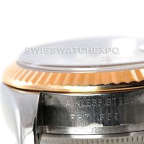 The image shows a close-up of the side case and fluted bezel of a Rolex Datejust 179173 Women's Steel and Gold (two tone) Silver Dial 179173 Women's Steel and Gold (two tone) Silver Dial watch, highlighting the stainless steel and serial number.