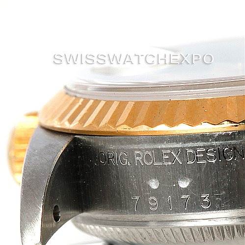 The image shows a side view of a Rolex Datejust 79173 Women
s Stainless Steel White Dial 79173 Women
s Stainless Steel White Dial watch, highlighting the case, bezel, and part of the crown with engravings visible.