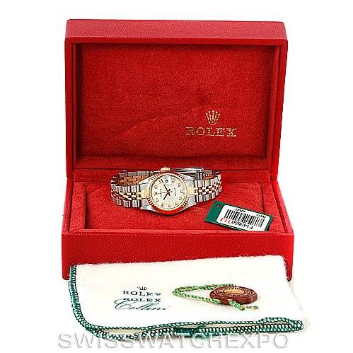 The Rolex Datejust 79173 Women's Stainless Steel Silver Dial 79173 Women's Stainless Steel Silver Dial watch is pictured inside an open red Rolex box, with accessories including a tag and cleaning cloth placed in front.