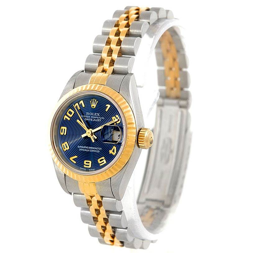 The image displays a Rolex Datejust 69173 Women
s Stainless Steel Blue Dial 69173 Women
s Stainless Steel Blue Dial watch at an angle showing the face, bezel, crown, and two-tone bracelet.