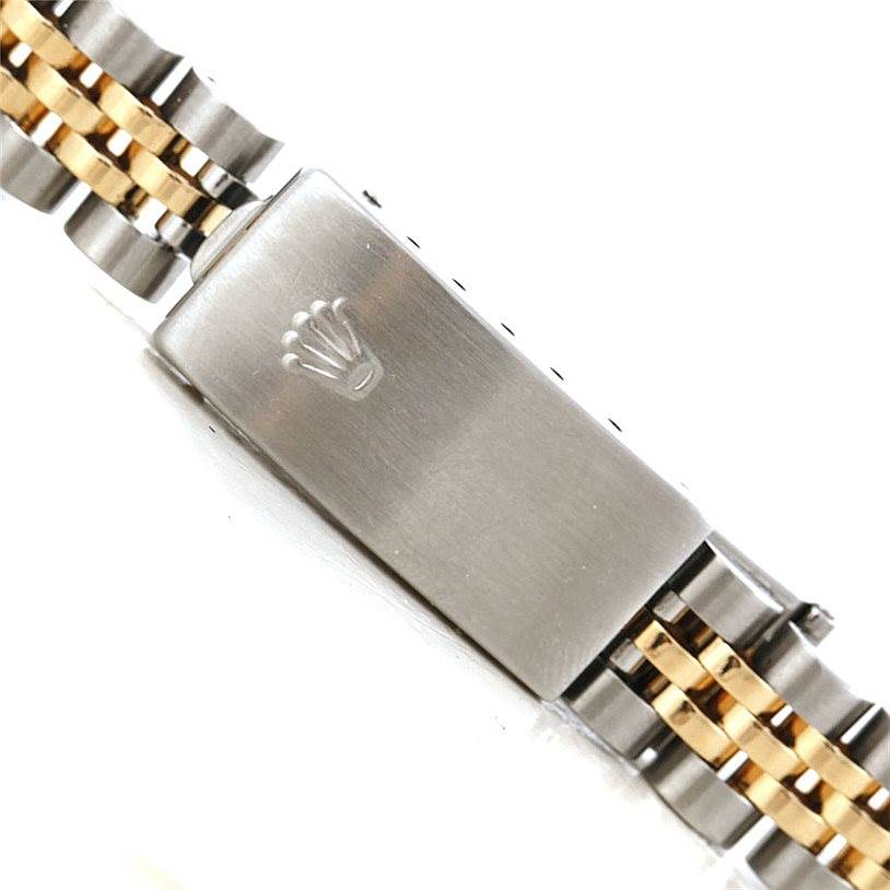 The image shows the clasp of a Rolex Datejust 79173 Women's Stainless Steel Mother of Pearl Dial 79173 Women's Stainless Steel Mother of Pearl Dial watch bracelet, featuring the Rolex crown logo with gold and silver links.