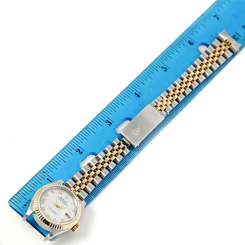 This image shows a Rolex Datejust 79173 Women's Stainless Steel Mother of Pearl Dial 79173 Women's Stainless Steel Mother of Pearl Dial model watch laying flat with the face, bezel, and jubilee bracelet visible, measured against a ruler.