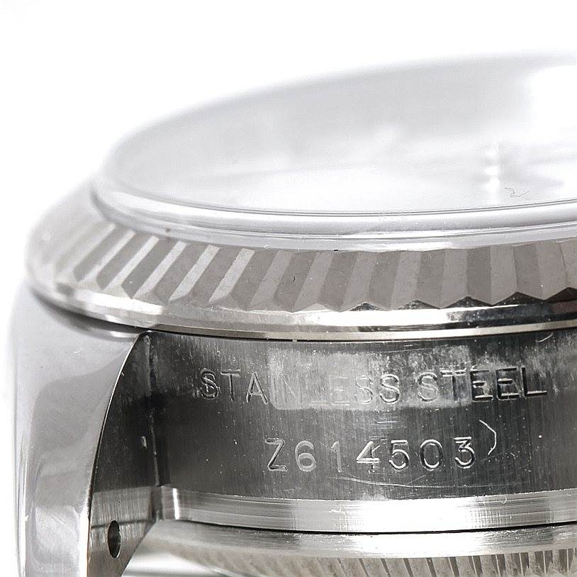This close-up angle shows the side of a Rolex Datejust 179174 Women's Stainless Steel Mother of Pearl Dial 179174 Women's Stainless Steel Mother of Pearl Dial watch, highlighting its stainless steel case and serial number.