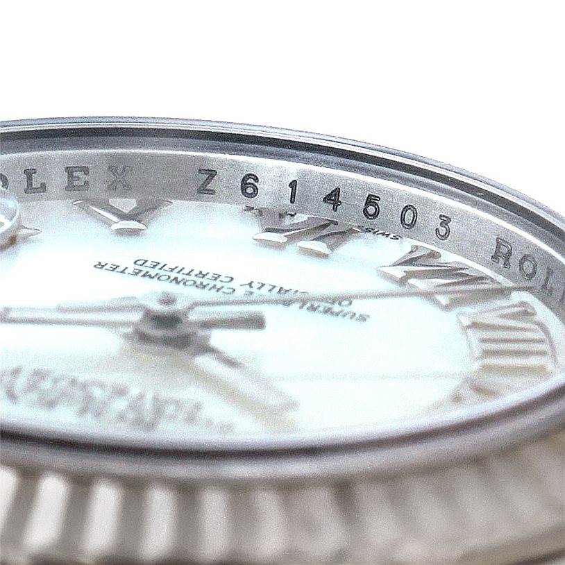 This image shows a close-up angle of the bezel, dial, and serial number of a Rolex Datejust 179174 Women's Stainless Steel Mother of Pearl Dial 179174 Women's Stainless Steel Mother of Pearl Dial watch.