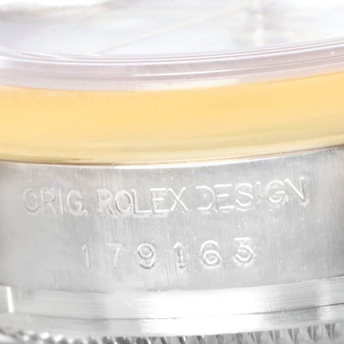 This close-up image shows the engraved serial number and case edge of a Rolex Datejust 179163 Women's Steel and Gold (two tone) White Dial 179163 Women's Steel and Gold (two tone) White Dial watch.