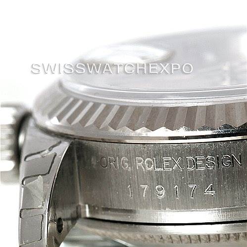 The image shows a close-up side view of the Rolex Datejust 179174 Women's Stainless Steel Pink Dial 179174 Women's Stainless Steel Pink Dial model, highlighting the bezel and part of the case with engraving.