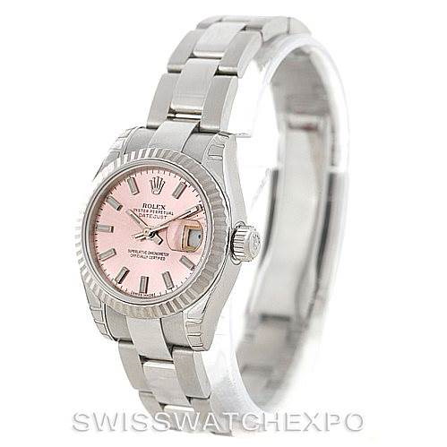 The image shows a Rolex Datejust watch angled slightly from above, featuring a pink dial, fluted bezel, and stainless steel bracelet.