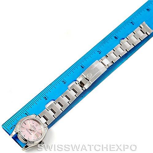 The image shows a Rolex Datejust 179174 Women's Stainless Steel Pink Dial 179174 Women's Stainless Steel Pink Dial watch laid out flat next to a blue ruler, highlighting its strap and face.