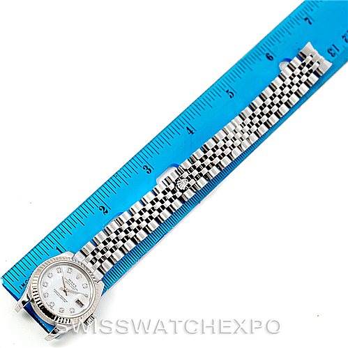 This image shows a Rolex Datejust 179174 Women's Stainless Steel Mother of Pearl Dial 179174 Women's Stainless Steel Mother of Pearl Dial watch laid flat next to a blue ruler, highlighting the bracelet and face of the watch.