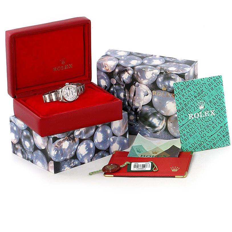 The image shows a Rolex Datejust 79174 Women's Stainless Steel Mother of Pearl Dial 79174 Women's Stainless Steel Mother of Pearl Dial watch in its red box, with additional branded packaging, documents, and tags surrounding it.